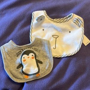 2 baby bibs. 1 NWT gap white bear face, 1 without tags gray penguin bib